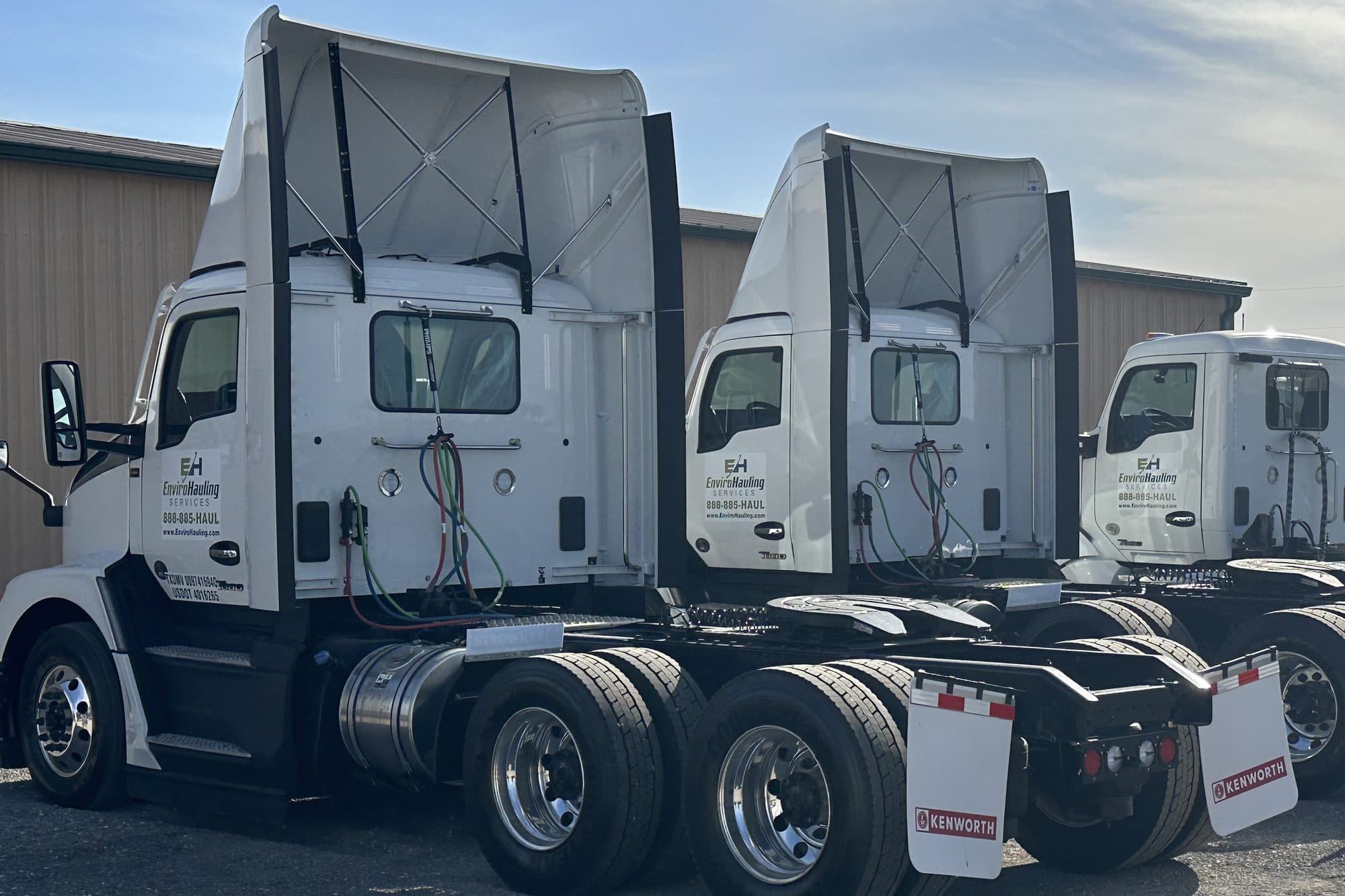 EnviroHauling day-cab tractors parked in a row