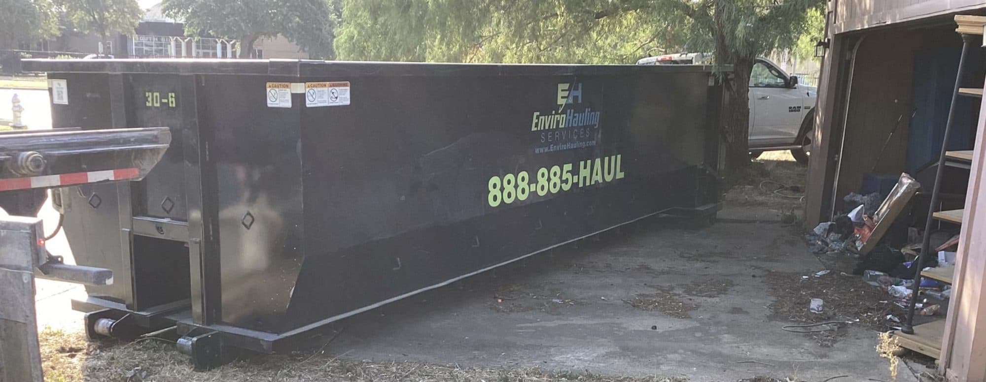 EnviroHauling roll-off container set on a residential jobsite